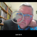 A man in blue glasses resting his chin in his hand with the subtitle "Just do it."