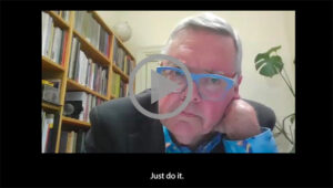 A man in blue glasses resting his chin in his hand with the subtitle "Just do it."