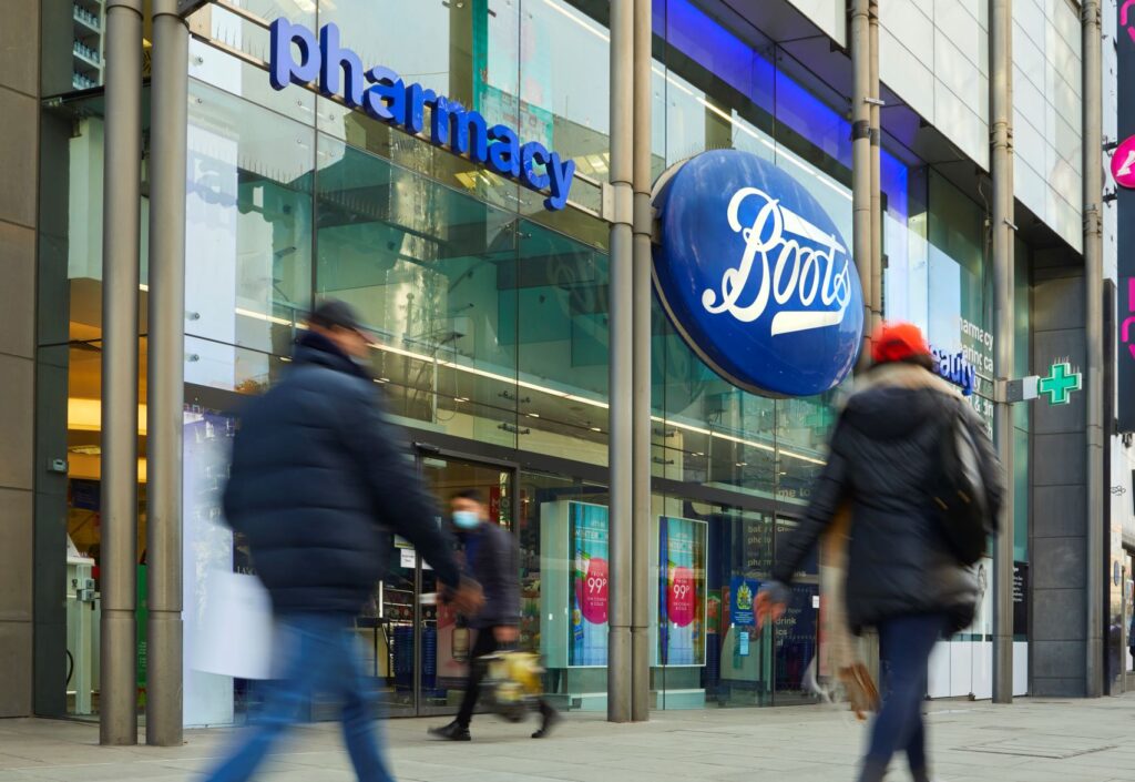 A high street store showing the Boots brand and blurry images of people walking past.