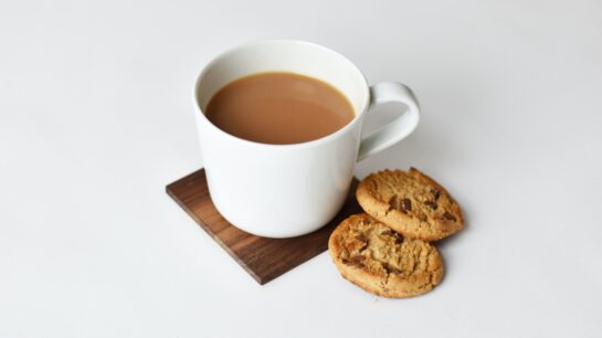 Photograph of a cup of tea and two biscuits